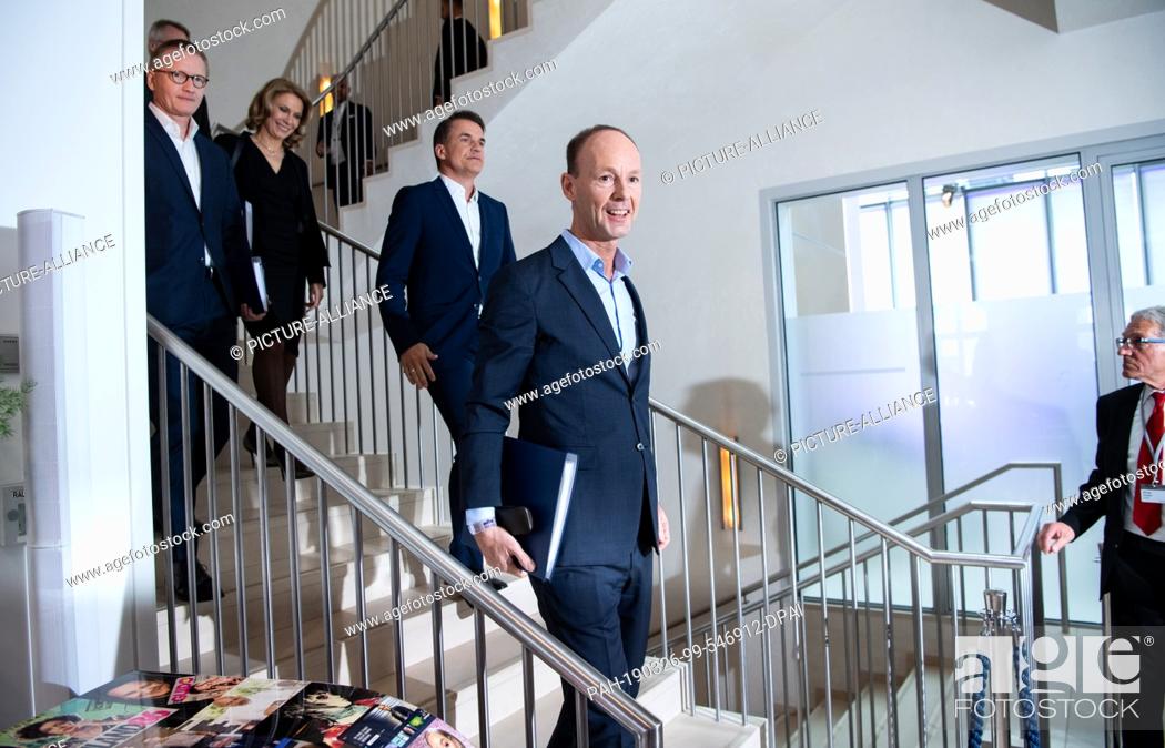 Stock Photo: 26 March 2019, Berlin: Executive Board members Thomas Rabe (M), CEO, Markus Dohle (3rd from left), CEO of Penguin Random House, and Bernd Hirsch (l), CFO.