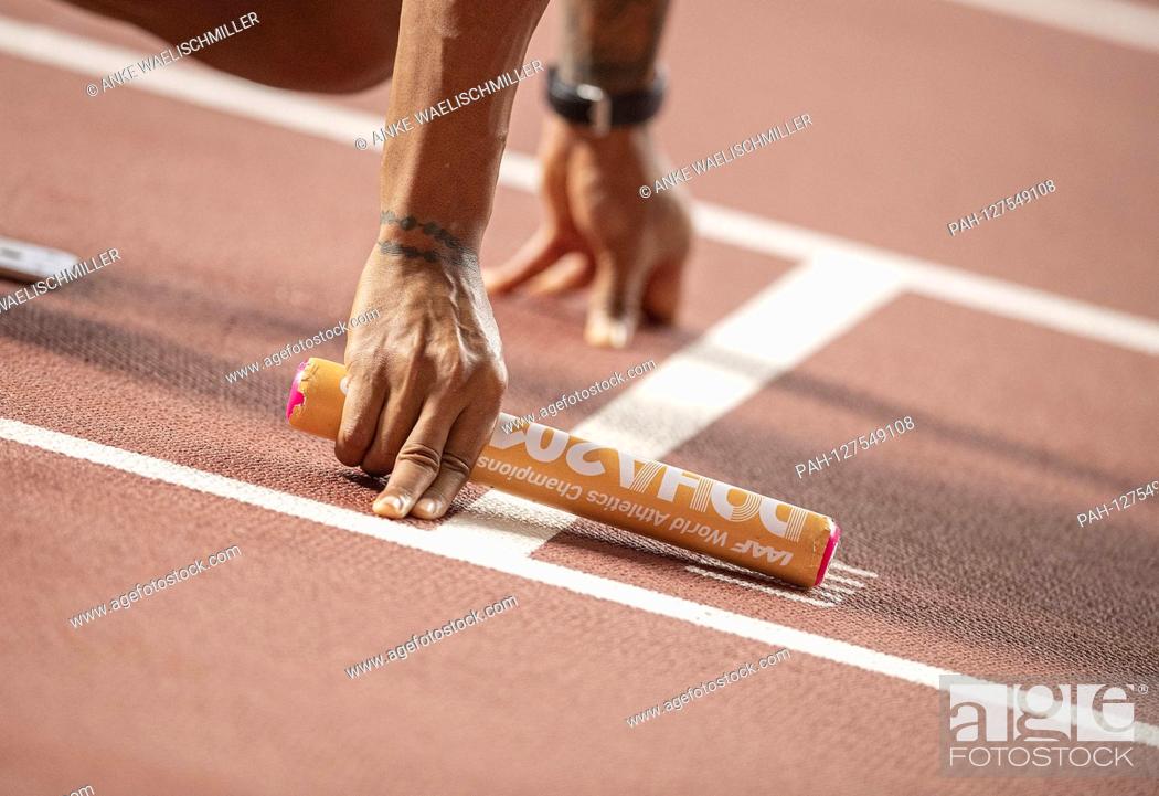 Stock Photo: Feature, baton with hands on the start, staff, final 4x100m Men's relay, on 05.10.2019 World Championships 2019 in Doha / Qatar, from 27.09. - 10.10.