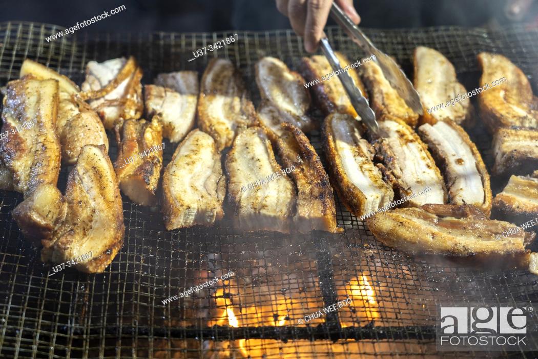 Stock Photo: Foodstall selling BBQ pork belly at the Kuching Intercultural Mooncake Festival, Sarawak, Malaysia.