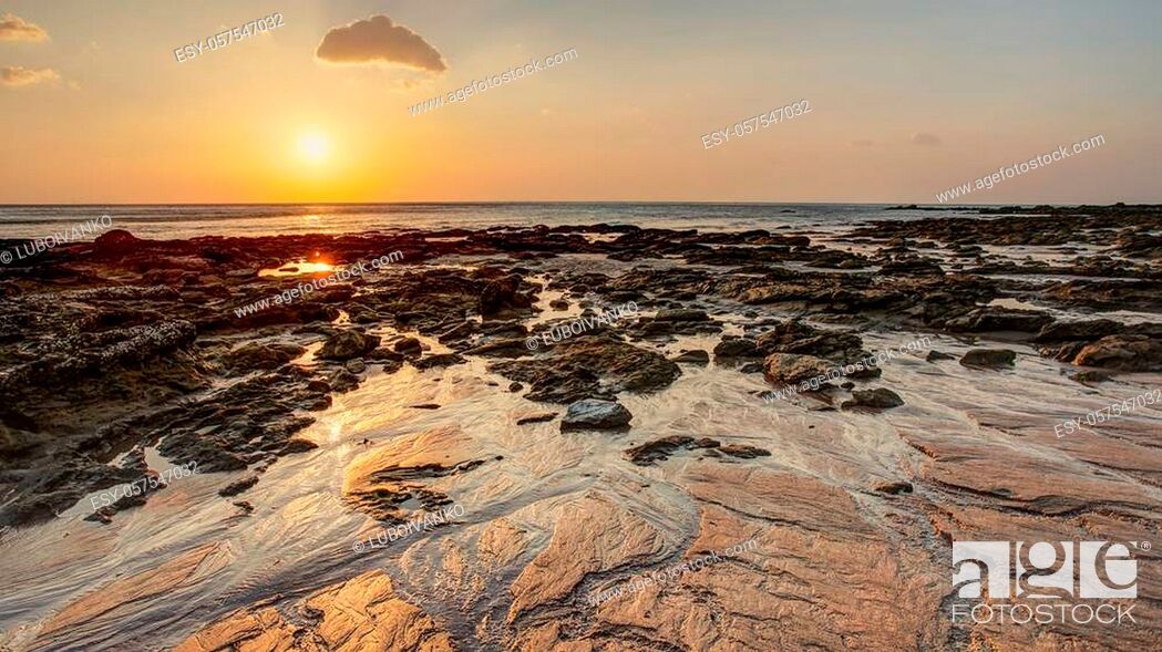 Stock Photo: Beach in golden sunset light during low tide showing sand formations and rocks not covered by the sea. Kantiang Bay, Ko Lanta, Thailand.