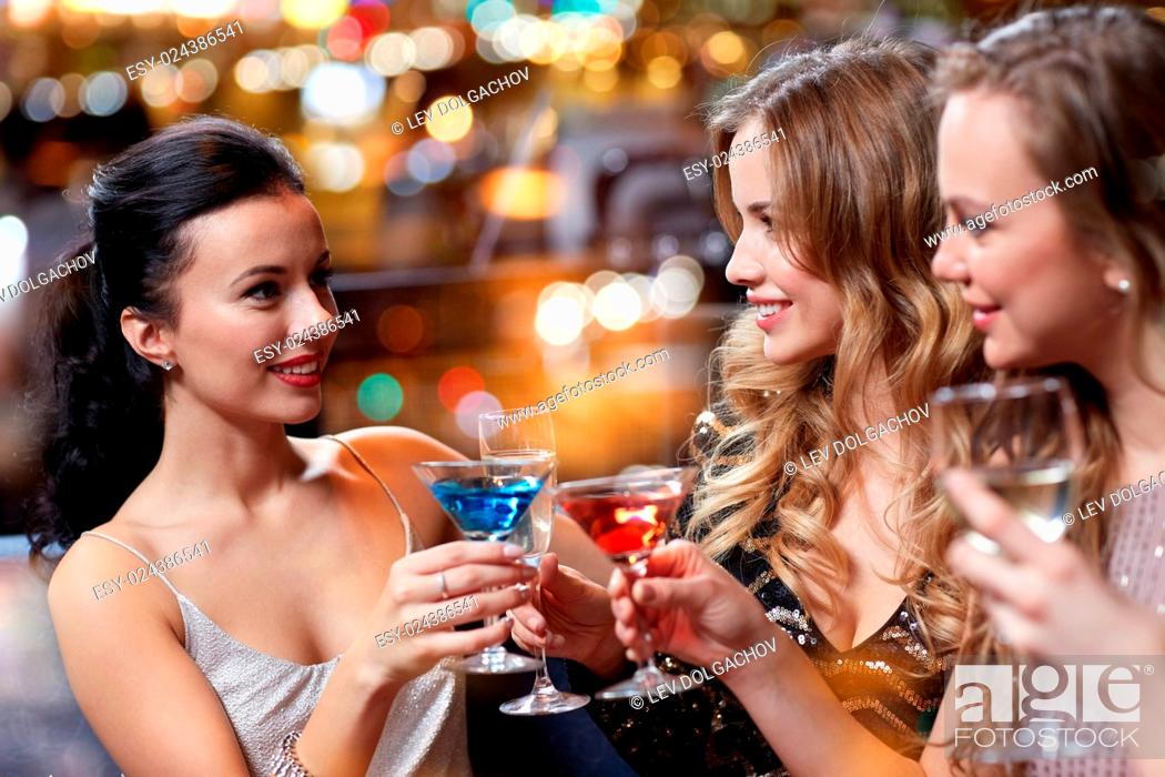 Stock Photo: celebration, friends, bachelorette party and holidays concept - happy women drinking champagne and cocktails at night club.