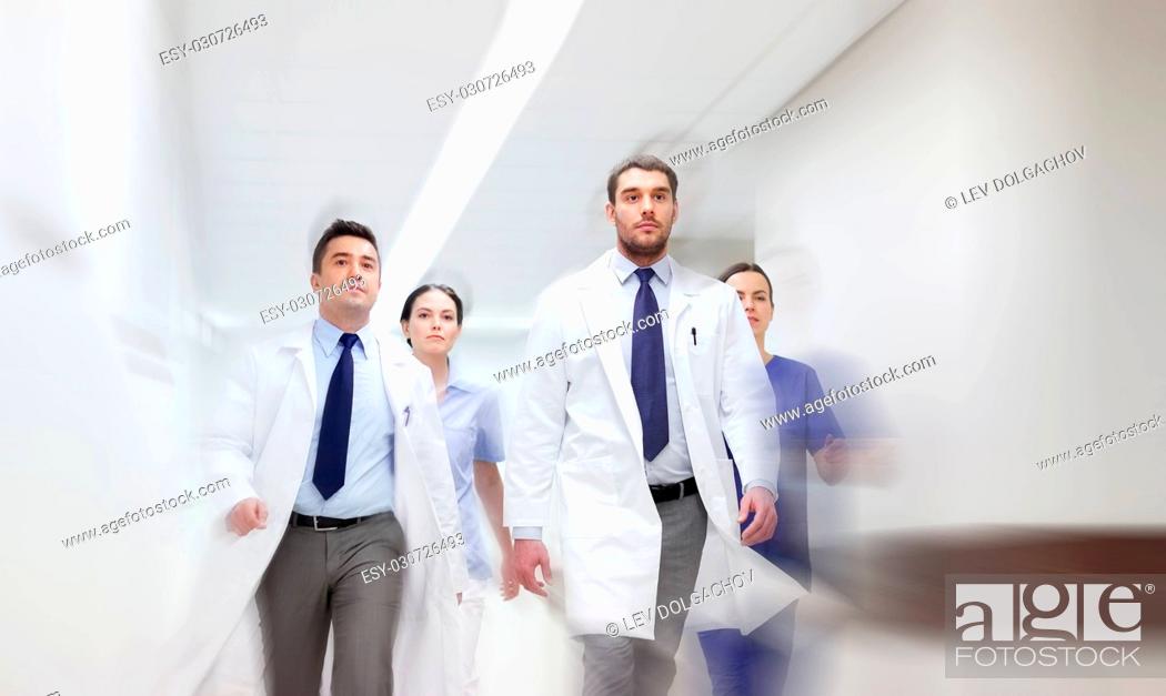 Photo de stock: people, health care and medicine concept - group of medics walking along hospital (motion blur effect).