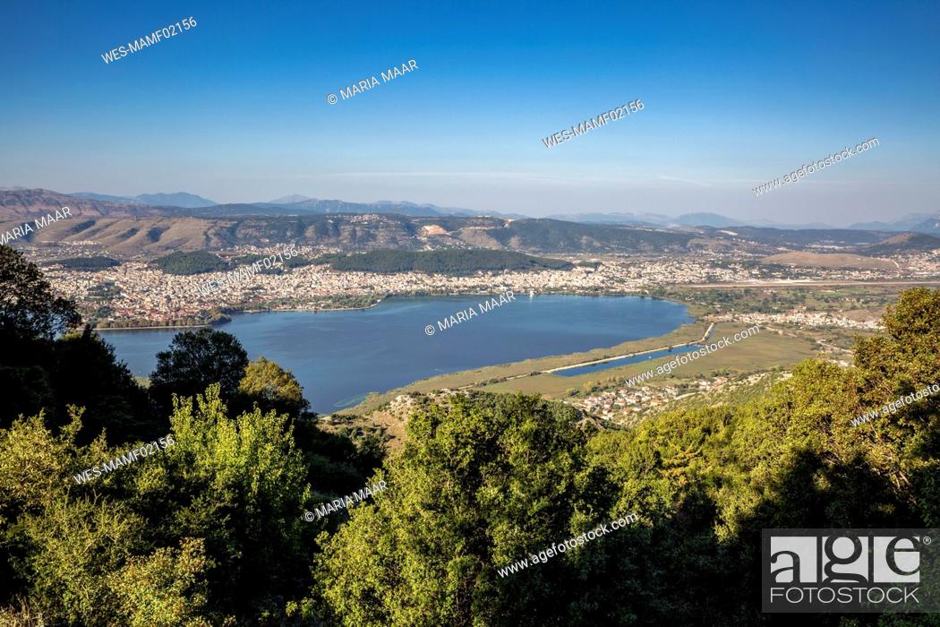 Stock Photo: Greece, Epirus, Ioannina, View of Lake Pamvotida and surrounding city in summer.