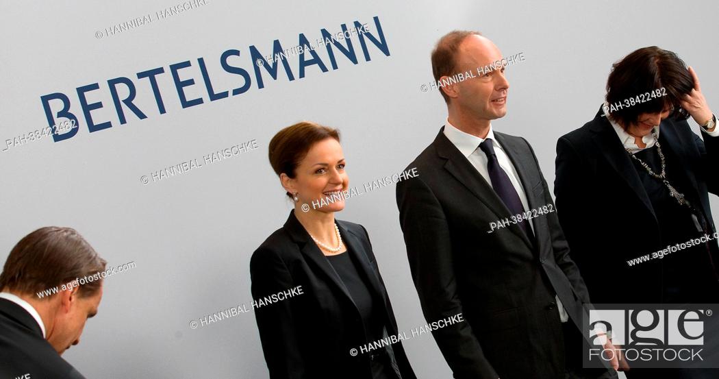 Stock Photo: CFO of Bertelsmann, Judith Hartmann (2-L), CEO of Bertelsmann, Thomas Rabe, CEO of broadcaster RTL in Germany, Anke Schaeferkordt pose for the camera at a press.