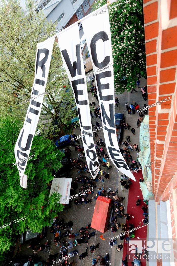Stock Photo: Banners reading 'Refugee Welcome Center' wave in front of a former school building, which will be used as 'Refugee Welcome Center' in future.