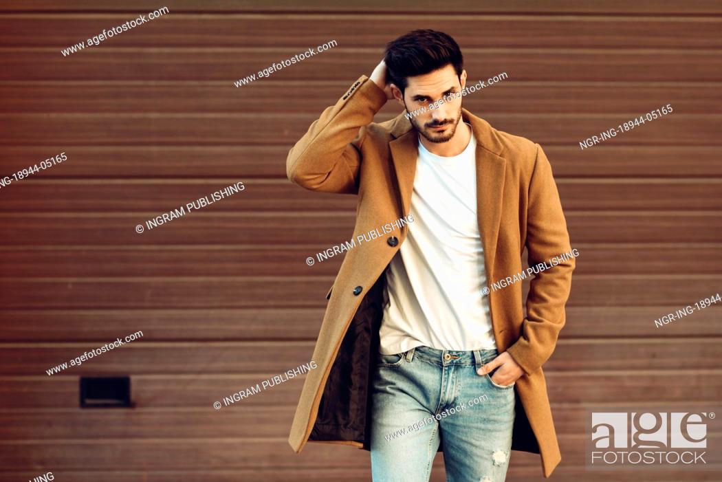 Young man wearing winter clothes in the street. Young bearded guy with  modern hairstyle with coat, Stock Photo, Picture And Royalty Free Image.  Pic. NGR-ING-18944-05165 | agefotostock