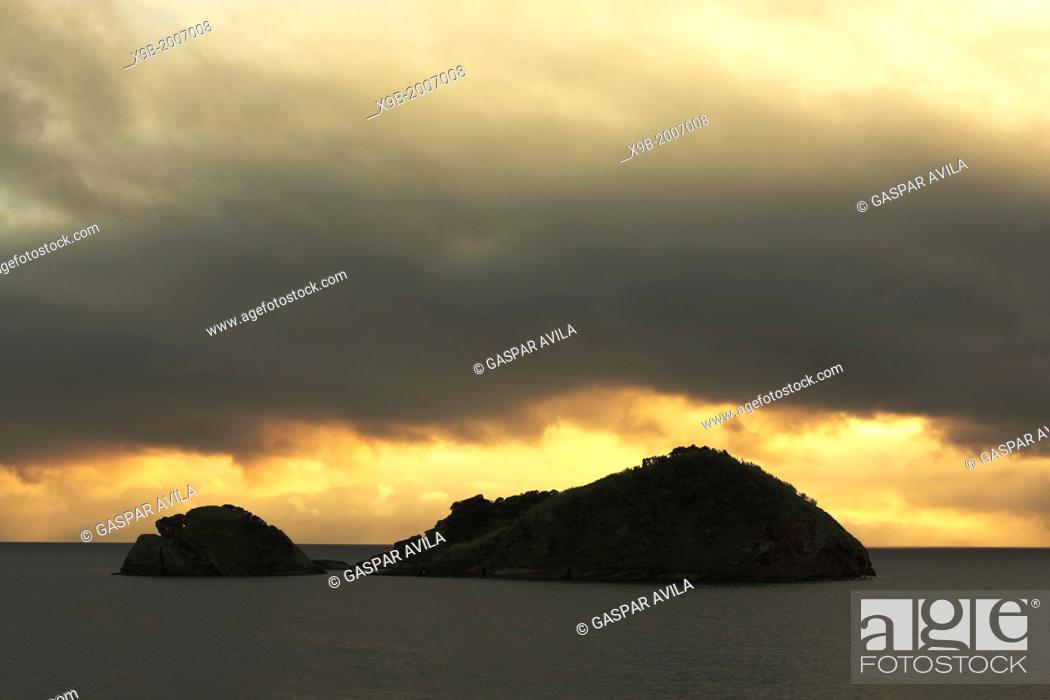 Stock Photo: Dark sunset clouds over the islet of Vila Franca do Campo, off the coast of Sao Miguel island. Azores, Portugal.