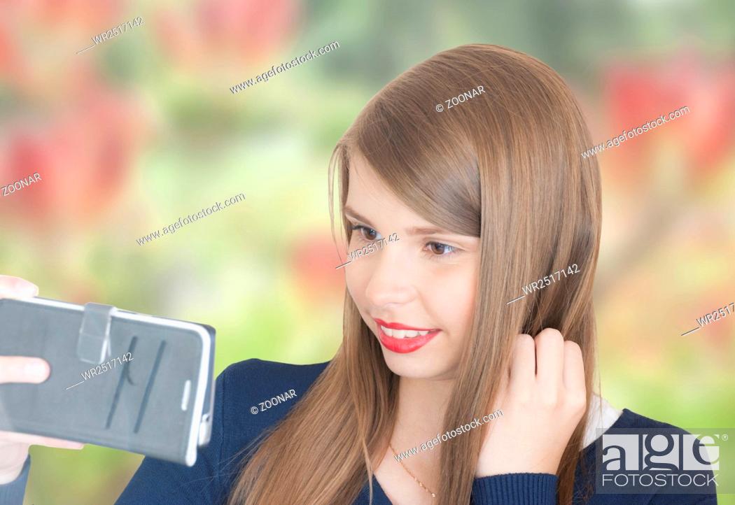 Stock Photo: Portrait of beautiful young girl with phone.