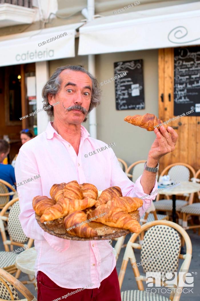 Stock Photo: Portrait of eccentric croissant seller, Ibiza, Spain.