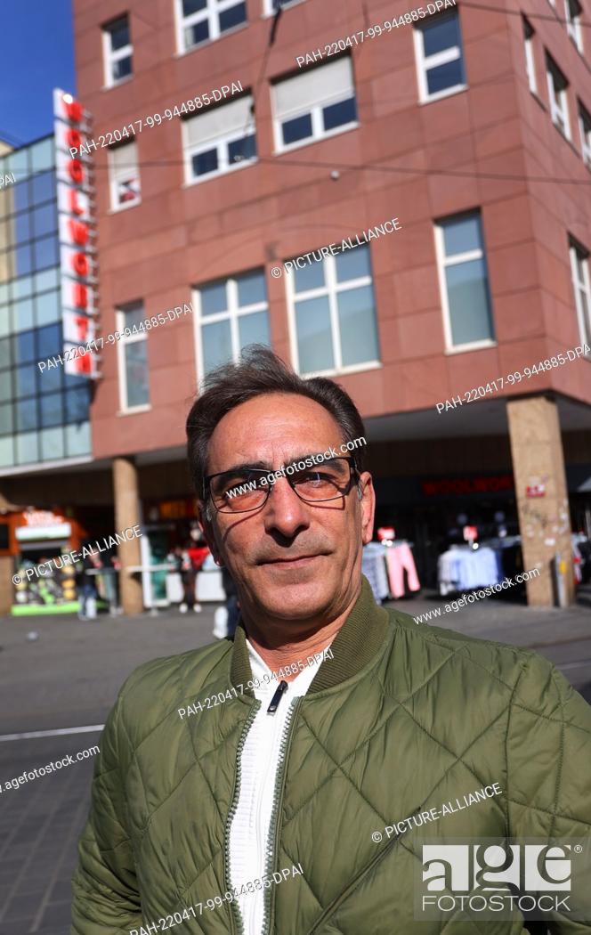 Stock Photo: 12 March 2022, Bavaria, Würzburg: Hossein Moradi is standing in front of a department store in the city center where he works as a store detective.