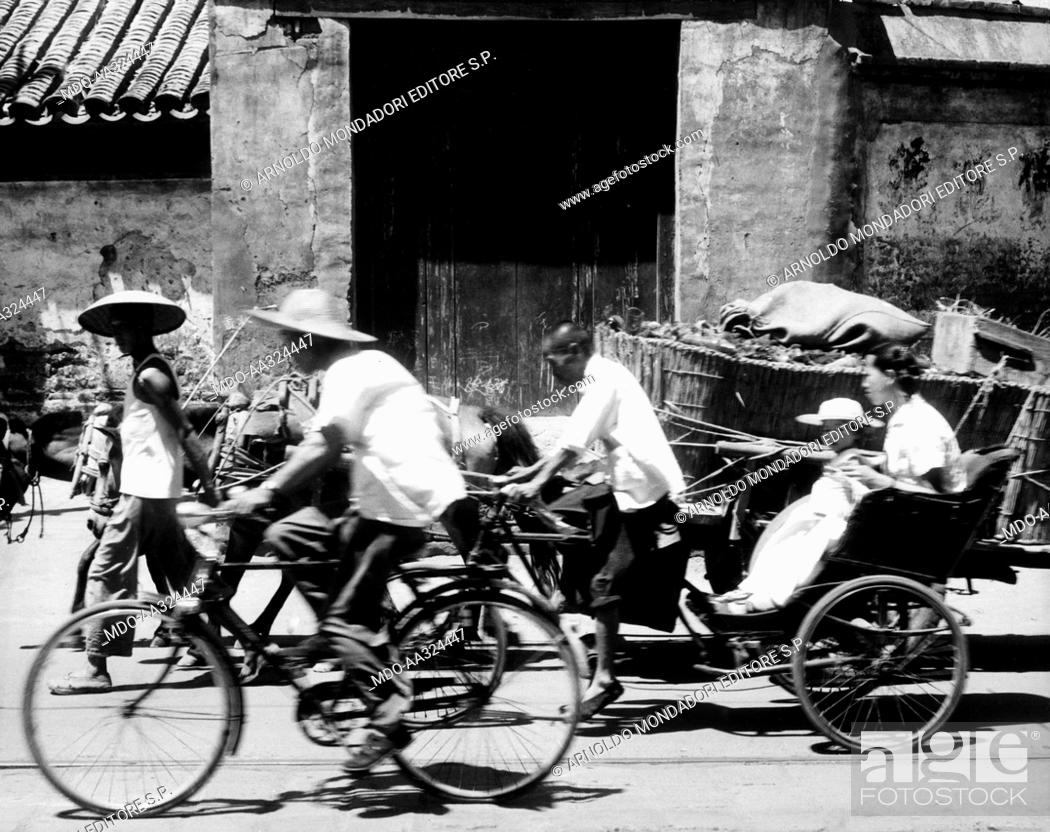 Bicycles, rickshaws and carts crossing the road. A Chinese road being  crossed by rickshaws, Stock Photo, Picture And Rights Managed Image. Pic.  MDO-AA324447 | agefotostock