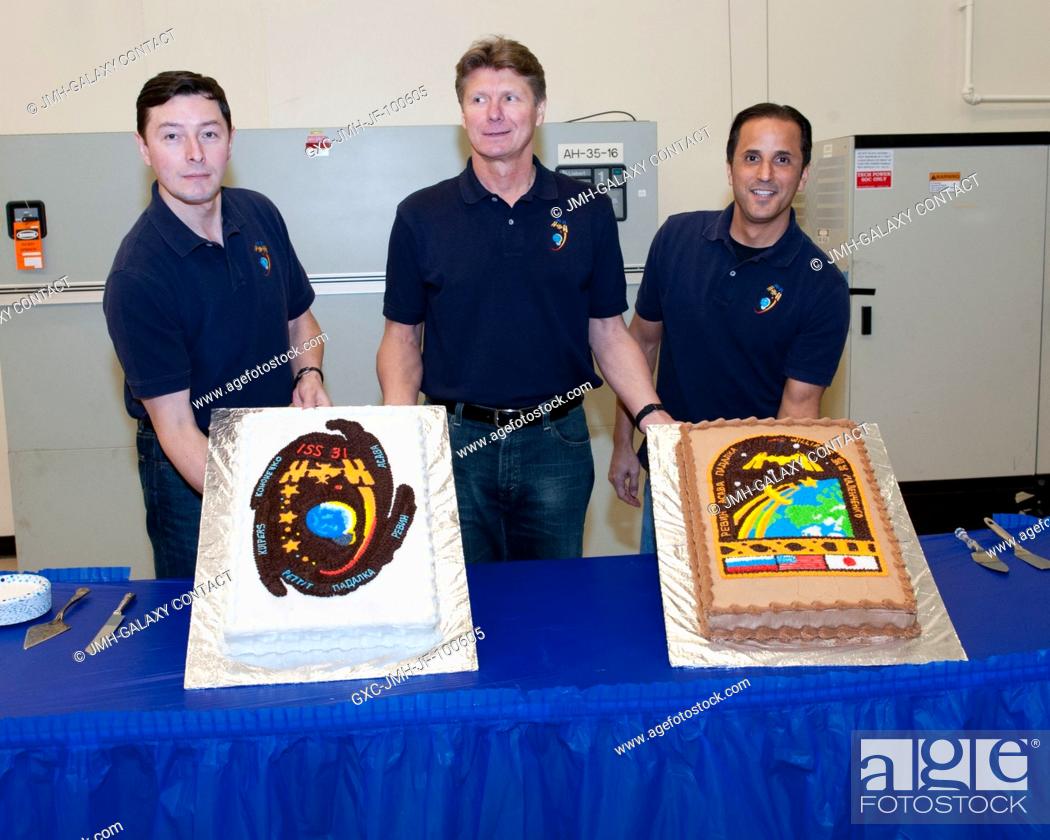 Stock Photo: Expedition 3132 crew members pose for a photo during a cake-cutting ceremony in the Jake Garn Simulation and Training Facility at NASA's Johnson Space Center.