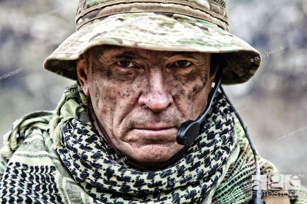 Imagen: Close-up portrait of brutal commando veteran, experienced army commander or officer with dirty face, wearing camouflage bonnie, shemagh.