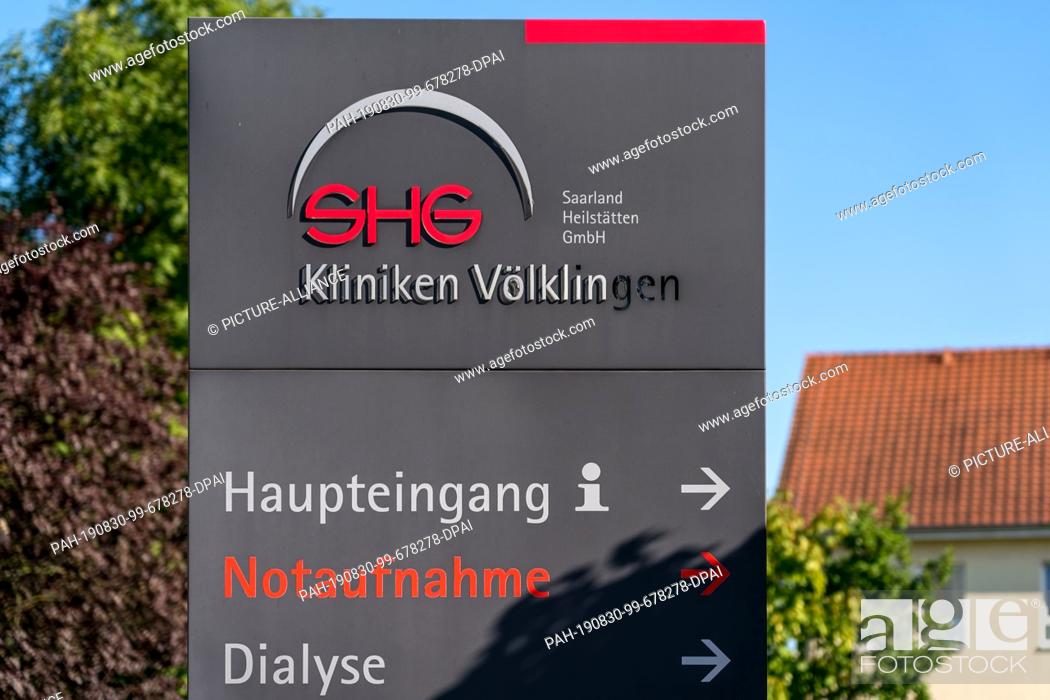Stock Photo: 30 August 2019, Saarland, Völklingen: A sign of the ""SHG Kliniken Völklingen"" points to the main entrance and the emergency room.