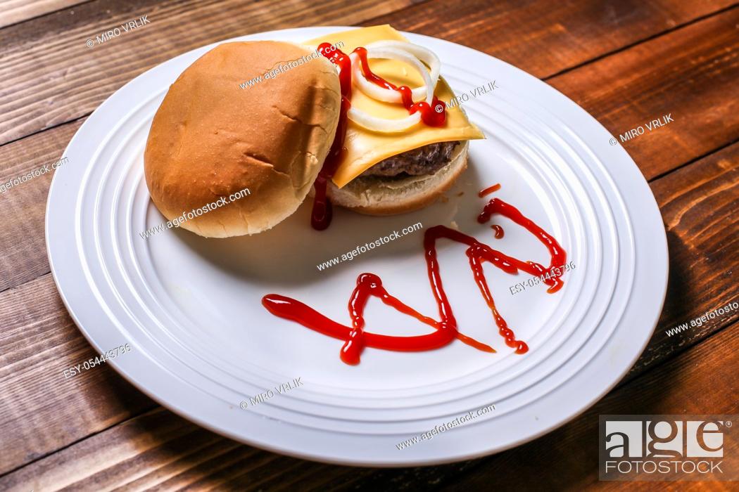 Stock Photo: Home made cheese burger on white plate.