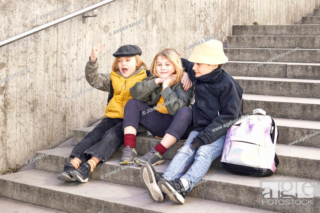 Stock Photo: Children sitting on stairs.