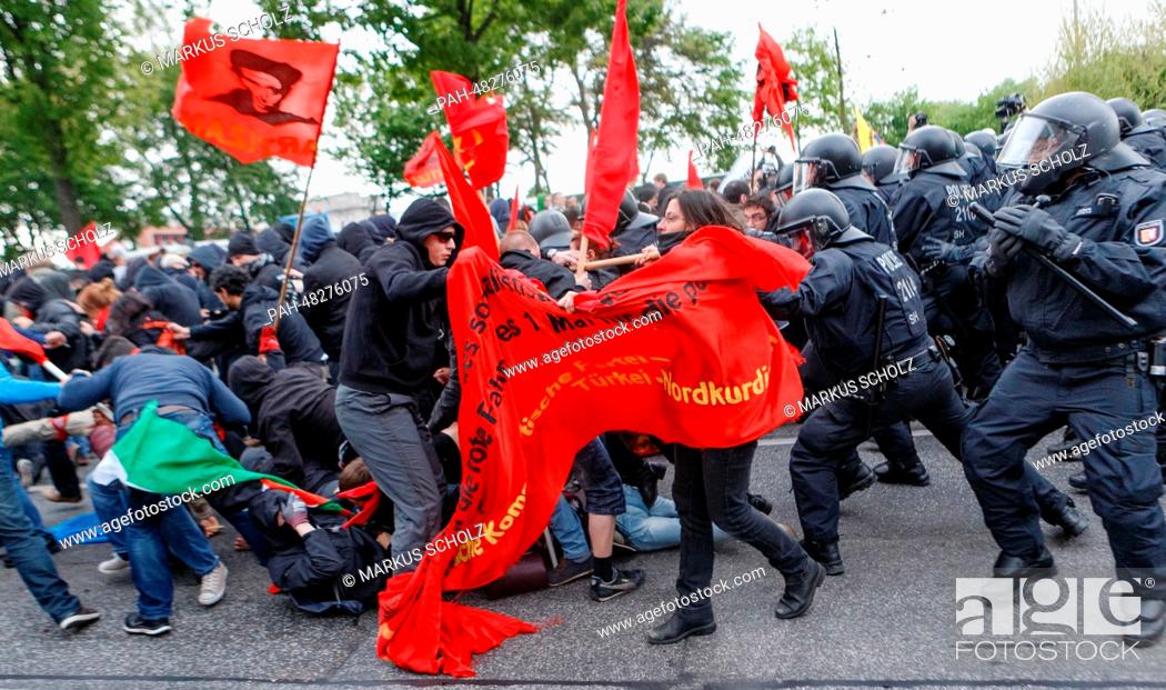 Stock Photo: Police officers stop demonstrators and force them onto a shortened route during the May Day demonstration in Hamburg, Germany, 01 May 2014.
