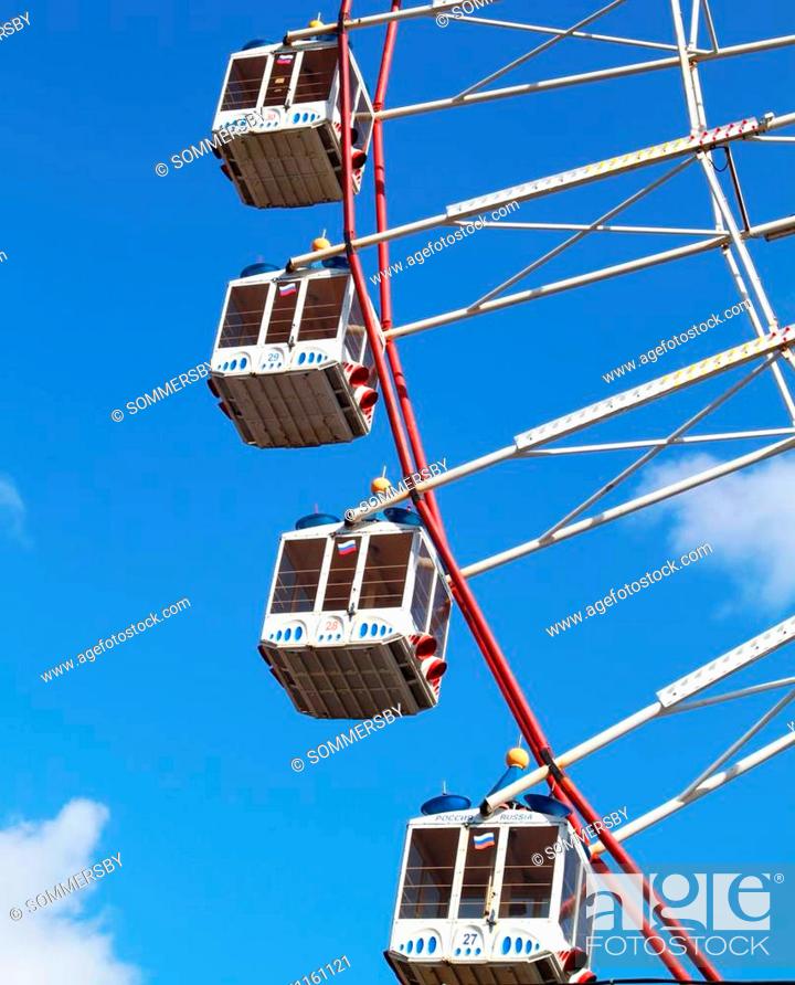 Stock Photo: Large Ferris wheel's cabins on the blue sky.