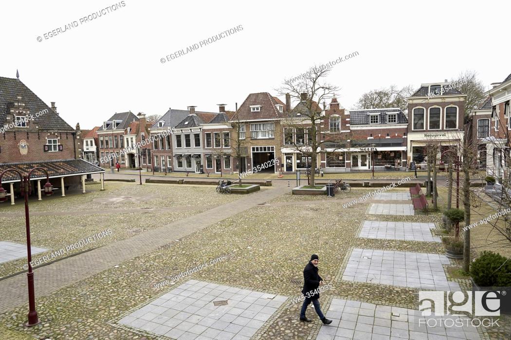 Photo de stock: man walking in city centre of Workum, Friesland, Netherlands.