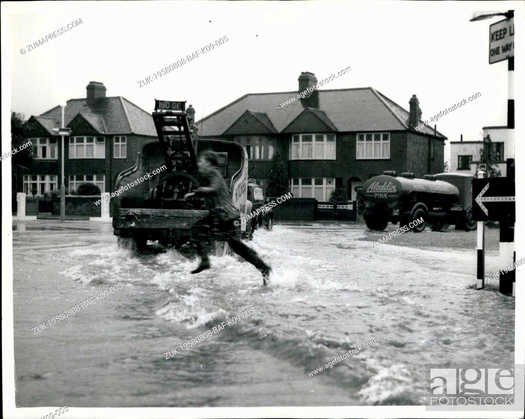 Stock Photo: Aug. 08, 1958 - Torrential Rains beings many floods. Waves in Eltham - London : Photo shows The scene at Eltham, London - yesterday -as a boy leaps into the.