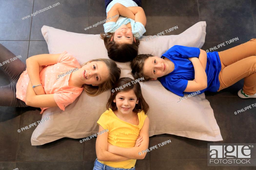 Stock Photo: Four children on a big pillow.