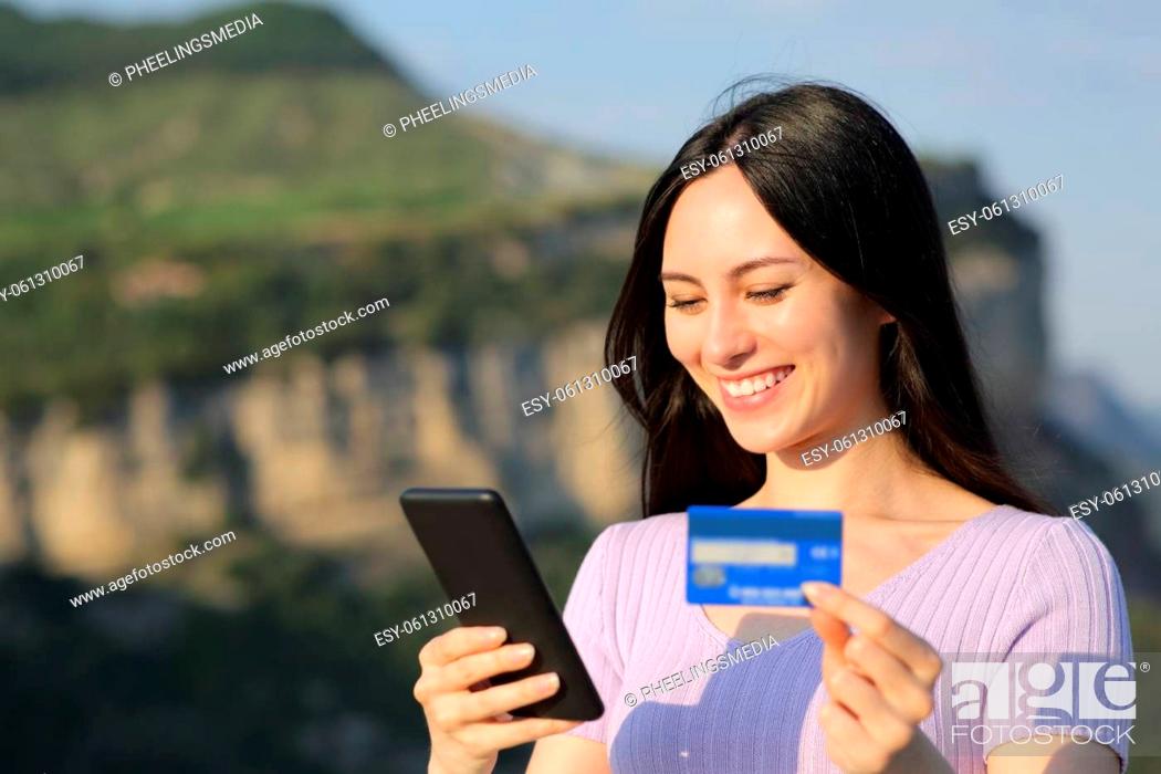Stock Photo: Asian woman buying online with credit card in nature.