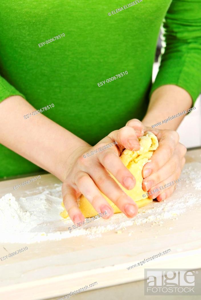 Stock Photo: Hands kneading dough.