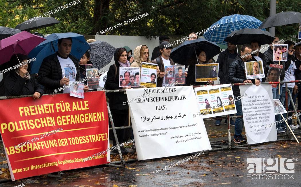 Stock Photo: A small group of demonstrators protest against the execution of political prisoners in Iran in front of the nation's embassy in Berlin, Germany, 10 October 2017.