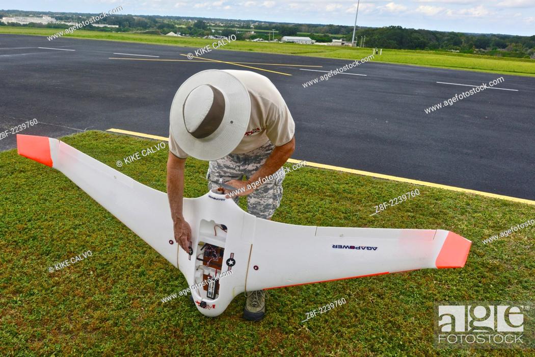 Stock Photo: Instructor Gene Payson holds a fixed-wing RC planes at a small unmanned aircraft pilot training course at the Unmanned Vehicle University.