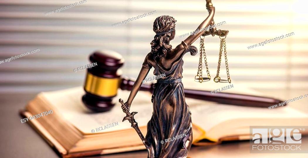 Stock Photo: Close-up view from behind of the Statue of Justice the Roman goddess in a lawyer office. ideal for websites and magazines layouts.