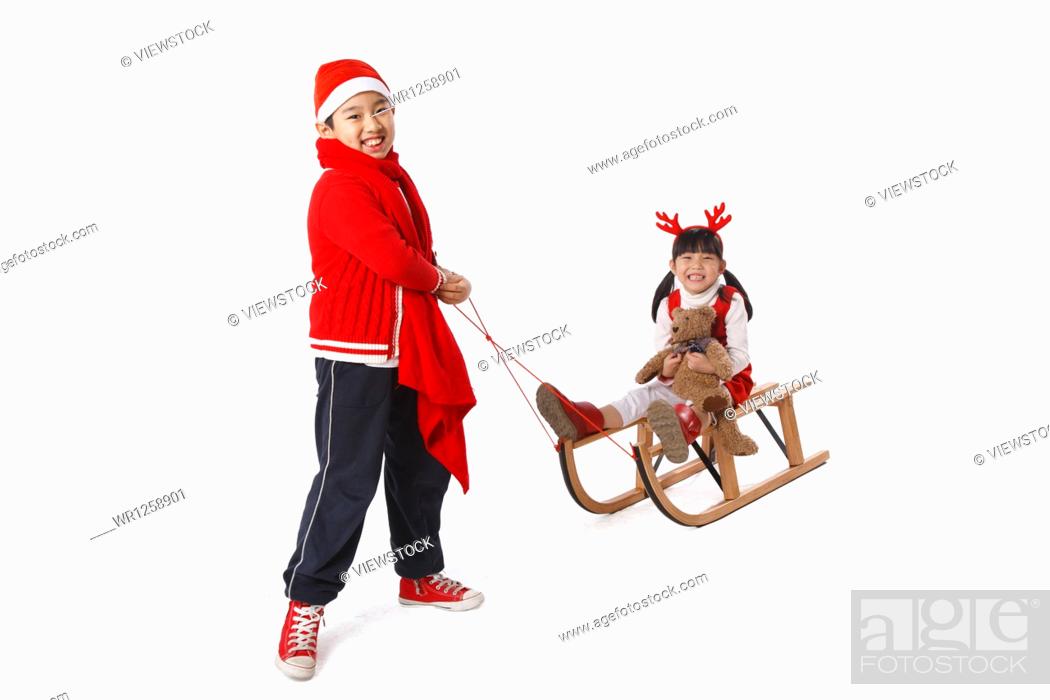 Stock Photo: Children playing sled at Christmas.