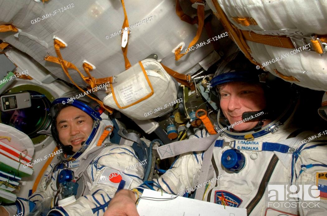 Stock Photo: Attired in Russian Sokol launch and entry suits, cosmonaut Gennady Padalka (right), Expedition 20 commander; and Japan Aerospace Exploration Agency (JAXA).