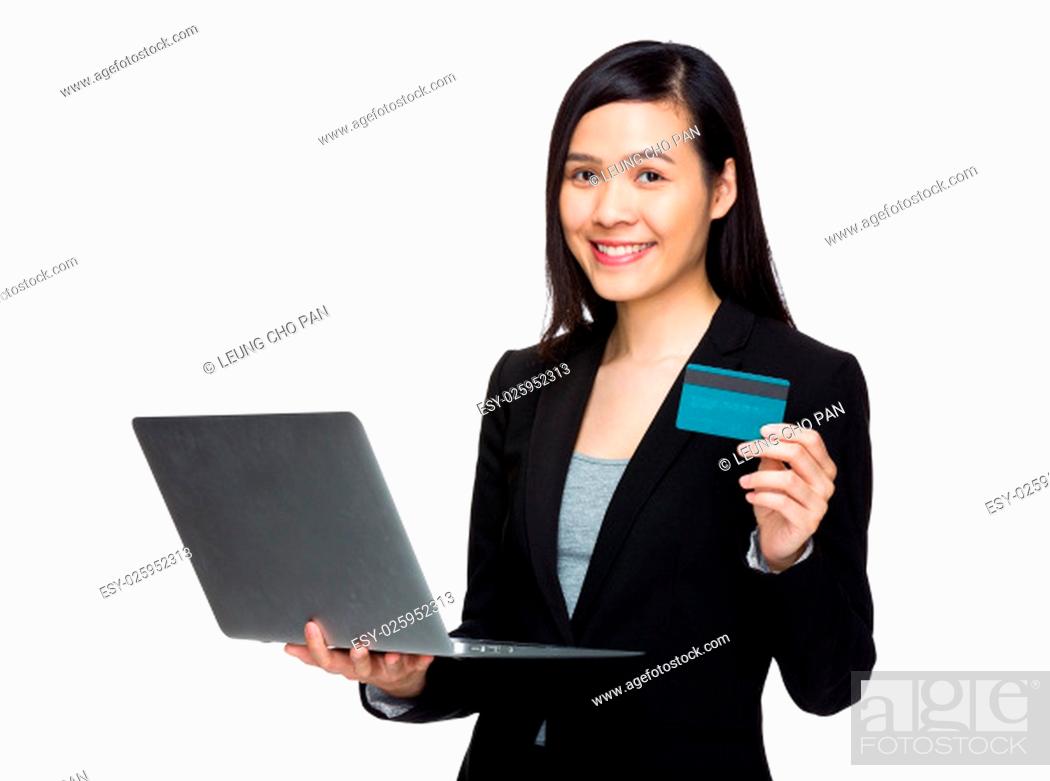 Stock Photo: Businesswoman holding credit card and laptop computer for online payment concept.