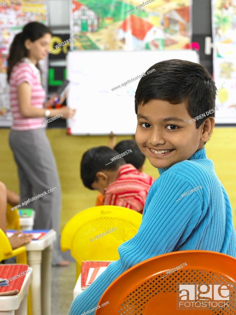 Photo de stock: South Asian Indian boy looking behind in nursery school MR.