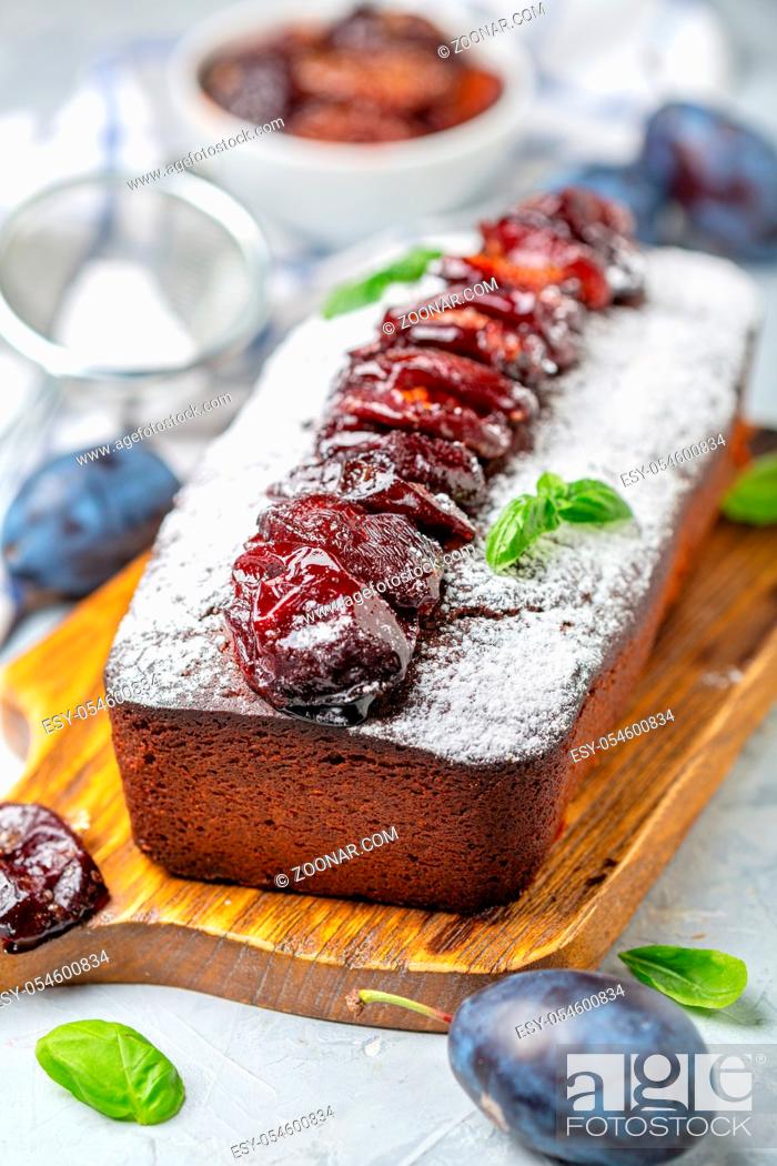 Stock Photo: Delicious plum cake with spicy plums on a wooden serving board close-up, selective focus.