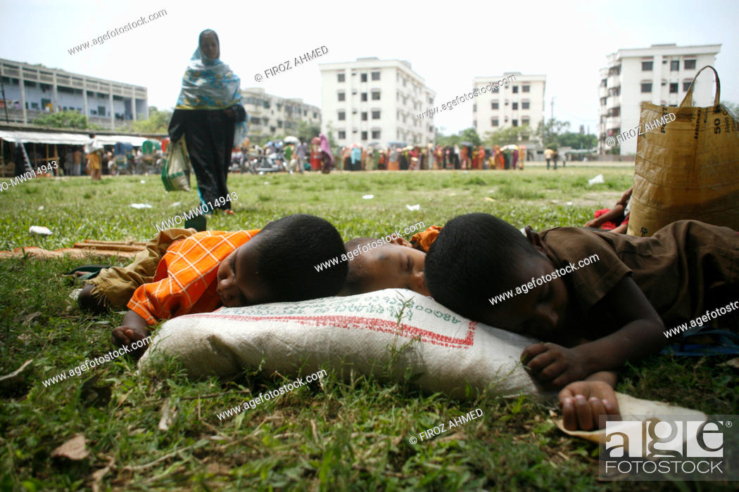Stock Photo: Children sleeping in the shade of trees while their parents trying to buy rice at a fair price shop, run by Bangladesh Rifles, BDR, in Dhaka Bangladesh April 04.
