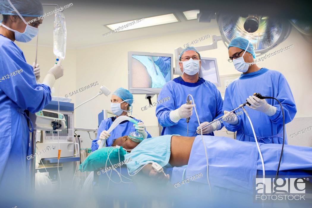 Stock Photo: Team of surgeons operating on patient in hospital.