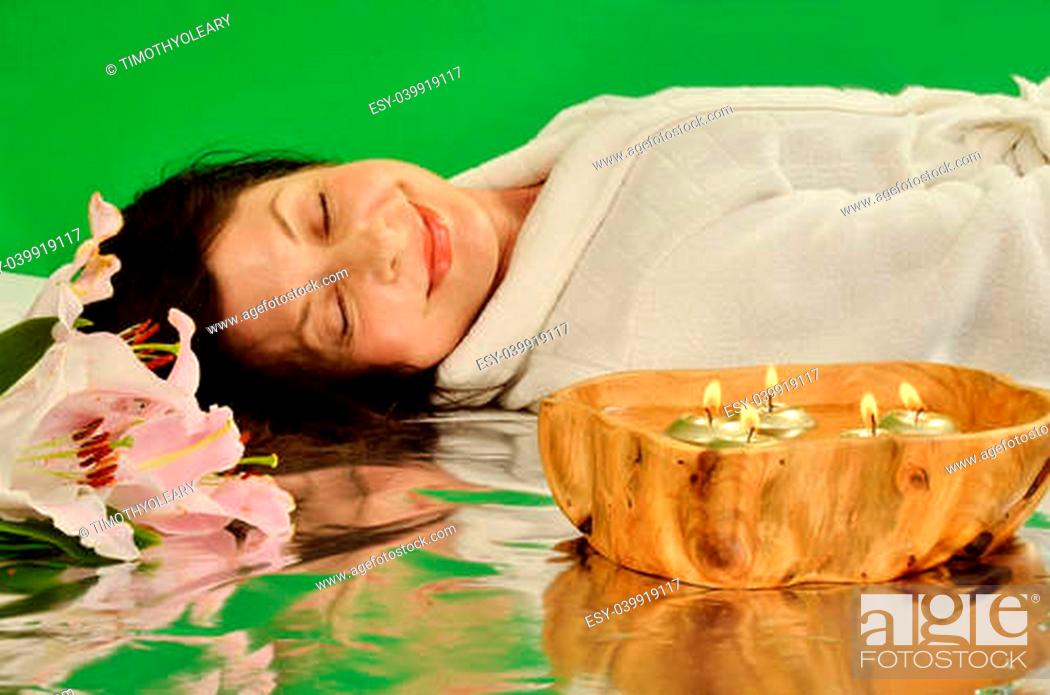 Stock Photo: Tranquil woman relaxing in a peaceful spa like setting.