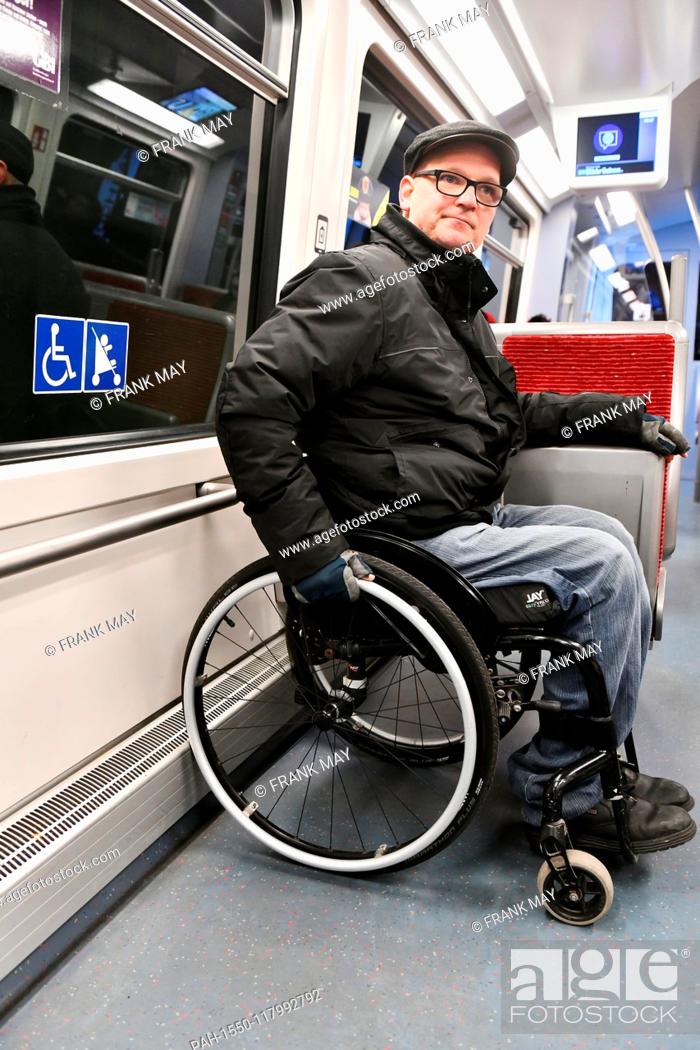Stock Photo: A Wheelchair user in a train, Germany, city of Hamburg, 05. March 2019. Photo: Frank May (model released) | usage worldwide.