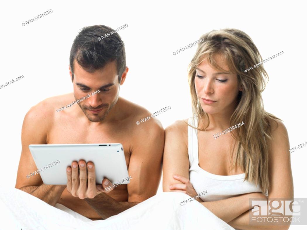Imagen: angry woman while his partner is watching a tablet.