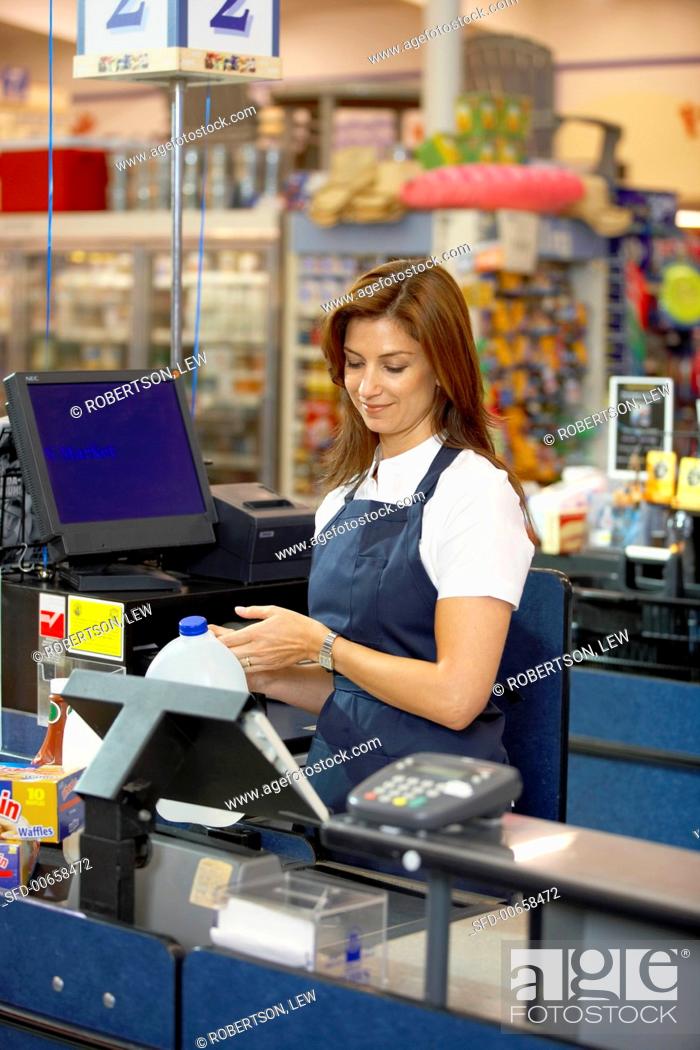 Stock Photo: Supermarket check-out girl at work (USA).