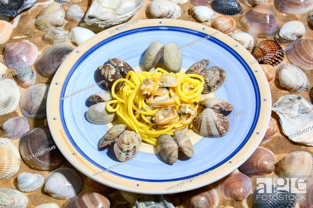 Stock Photo: Italian food for Mediterranean healthy diet, risotto with pumpkin, spaghetti with clams.
