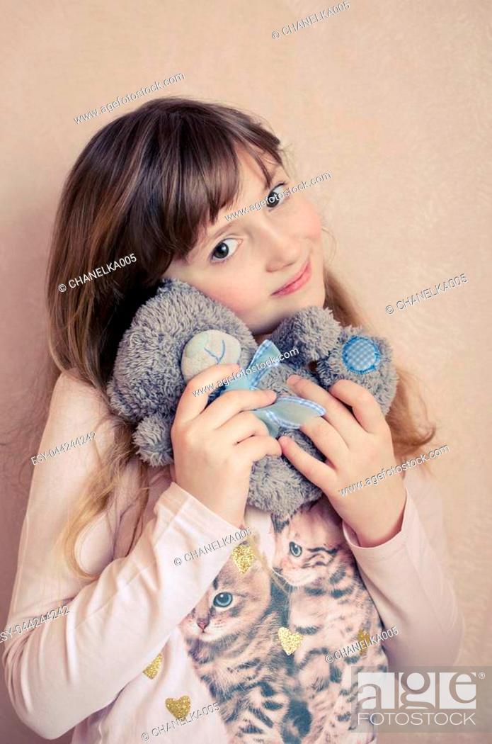 Little girl 8 years old with a small teddy bear on pink background smiling  and loves toys stuffed..., Stock Photo, Picture And Low Budget Royalty Free  Image. Pic. ESY-044244242 | agefotostock
