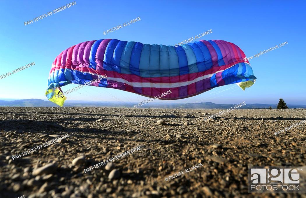 Stock Photo: 13 October 2018, Bavaria, Buching: 13 October 2018, Germany, Buching: A paraglider unfolds on the Buchenberg Alm at an altitude of around 1100 metres when.