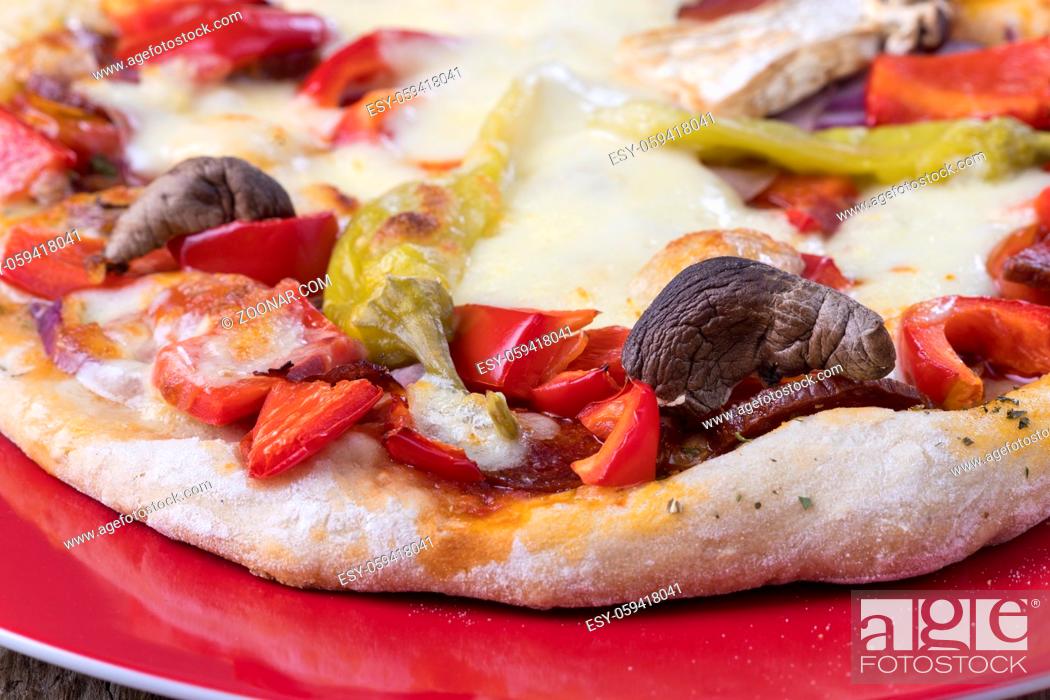 Stock Photo: closeup of a a pizza on a plate.