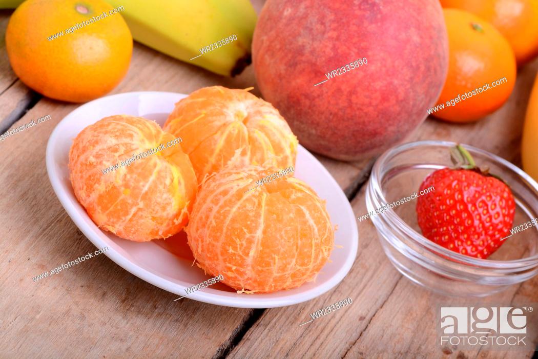 Stock Photo: Fresh colorful fruits composition mandarin, strawberry, peach, bananas and orange.