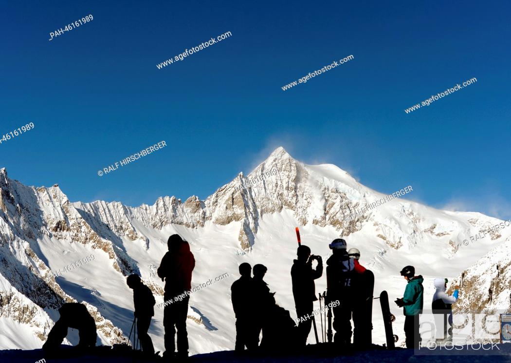 Stock Photo: Tourists look at the Aletsch Glacier from the 2, 900 meter high Eggishorn on a sunny day in Fiesch, Germany, 06 February 2014.
