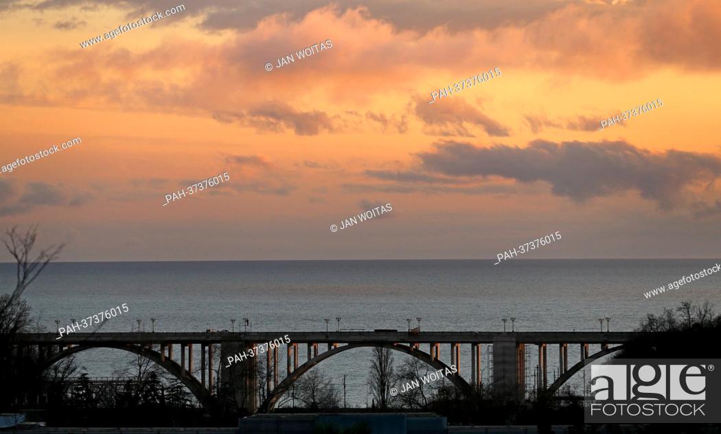 Stock Photo: A bridge spans the coastal road M27 along the Black Sea coast at dusk near Sochi, Russia, 5 February 2013. The Winter Olympics are going to take place in the.