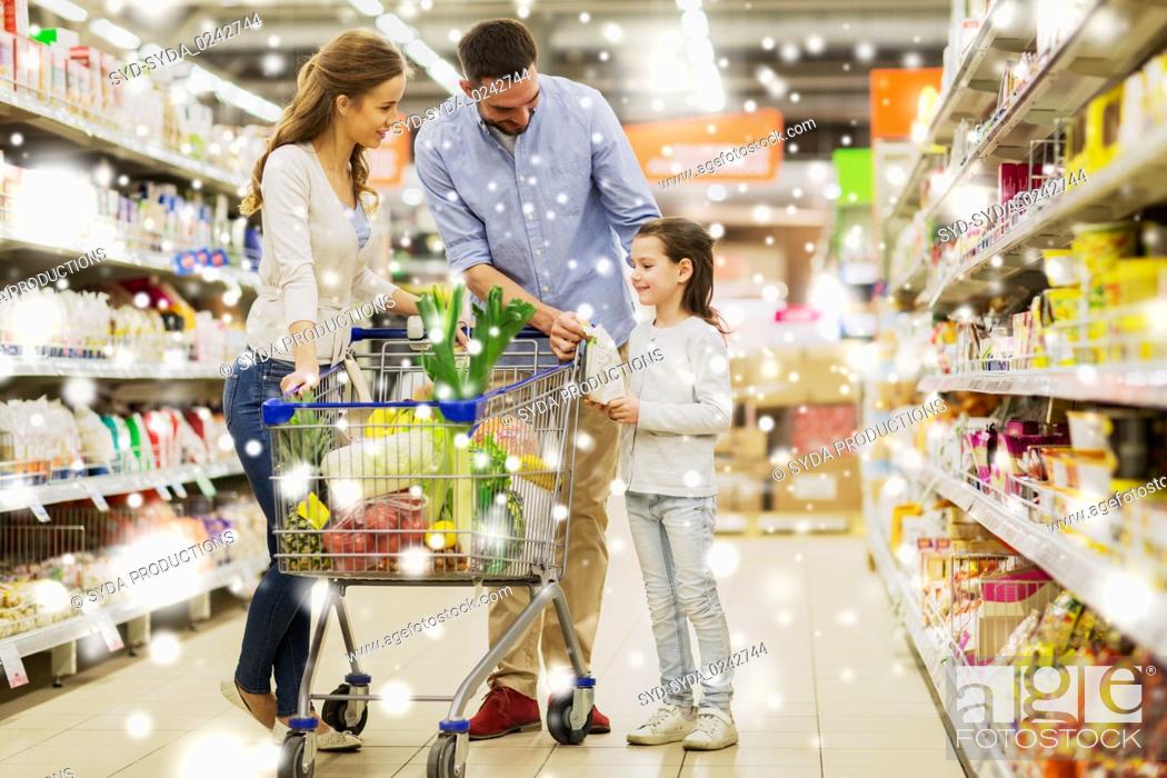 Stock Photo: family with food in shopping cart at grocery store.