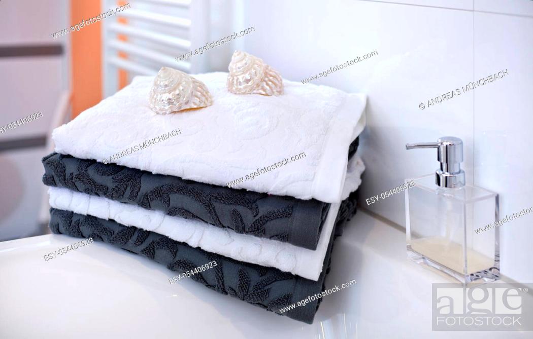 Stock Photo: stack of towels white and gray in modern clean bathroom decorated with shells and perfume.